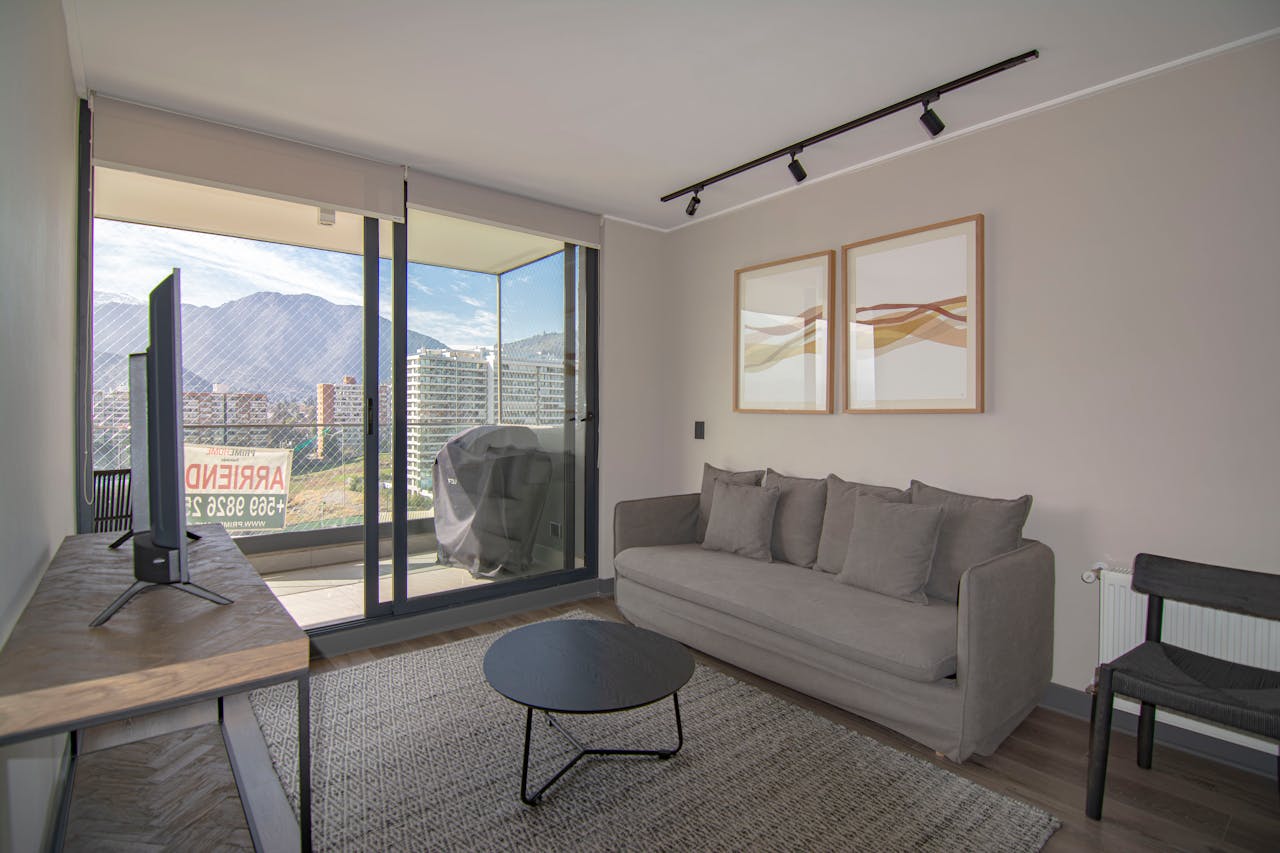 Contemporary living room featuring a cozy sofa, stylish decor, and stunning mountain view.