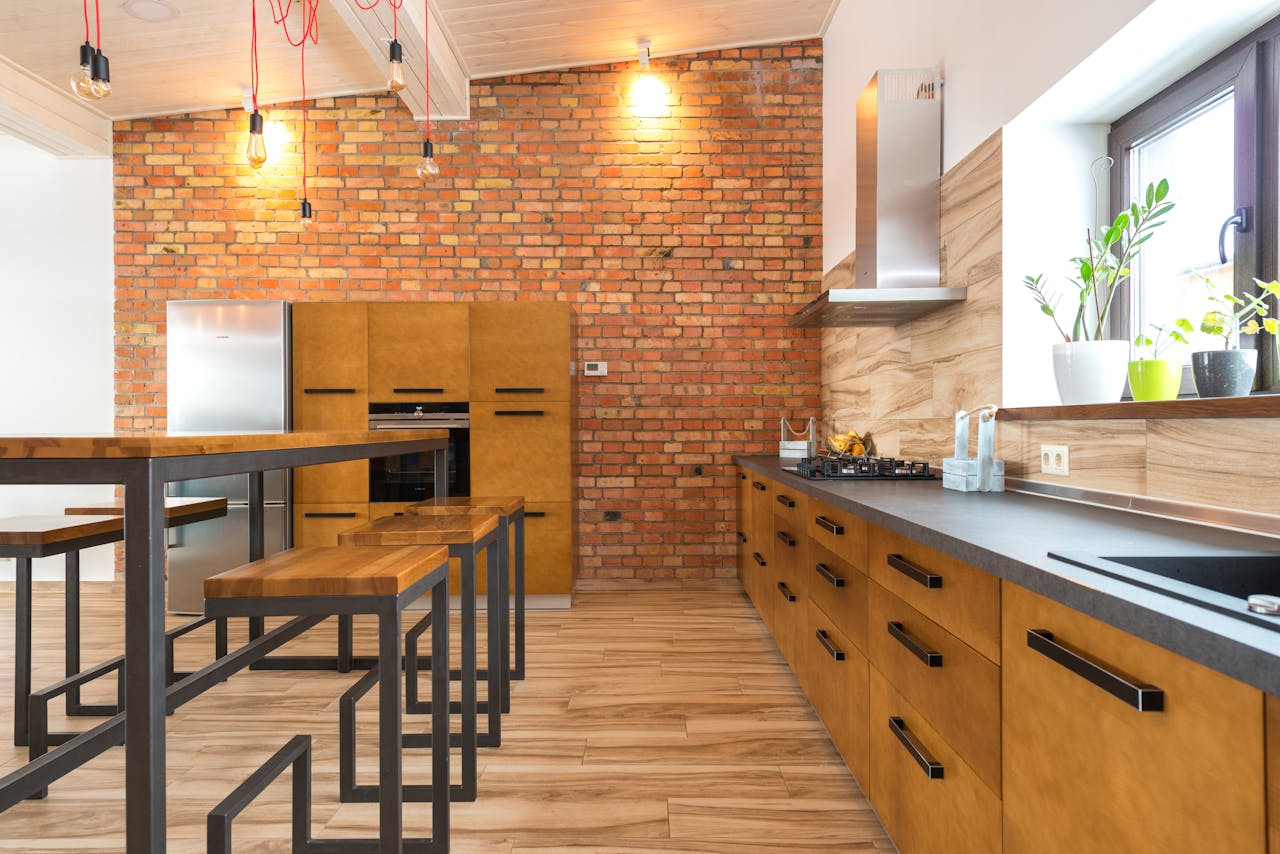 Mastering the First Impression: Your intriguing post title goes here Contemporary kitchen featuring brick wall, wooden cabinets, and sleek design elements with ample natural light.